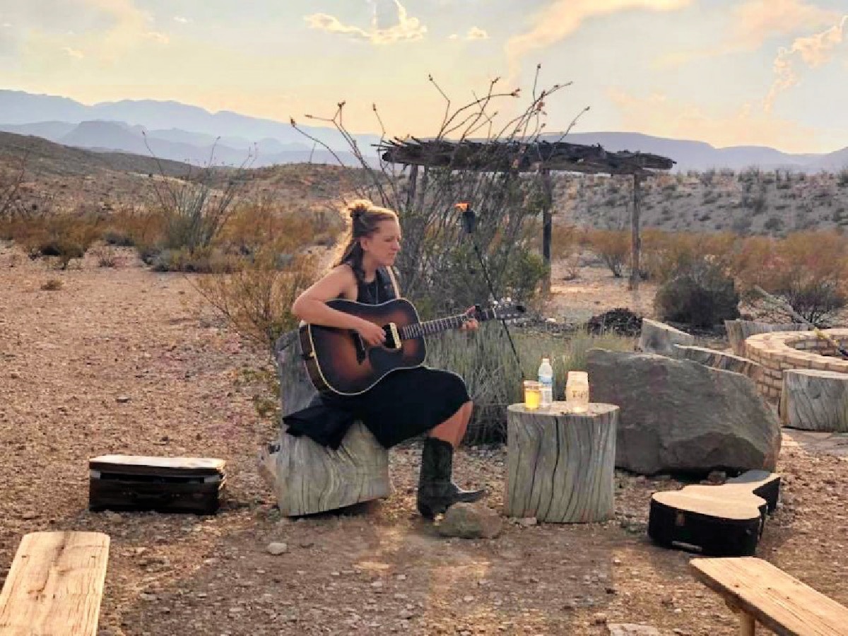 singer-playing-guitar-while-sun-sets-in-big-bend