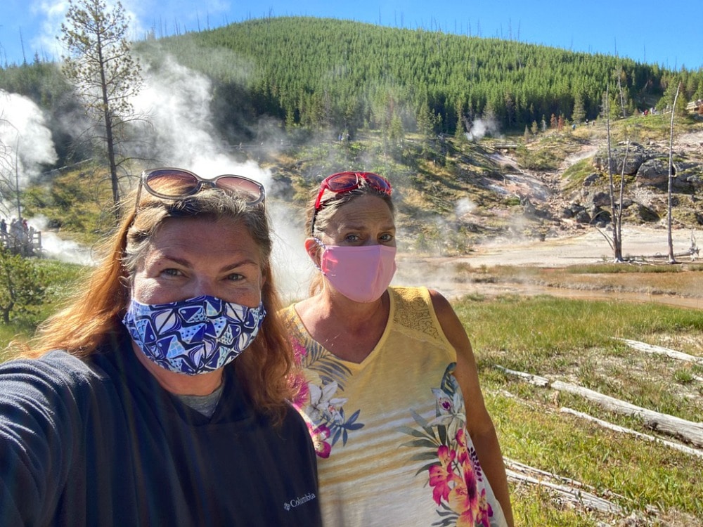 friends in masks visiting yellowstone